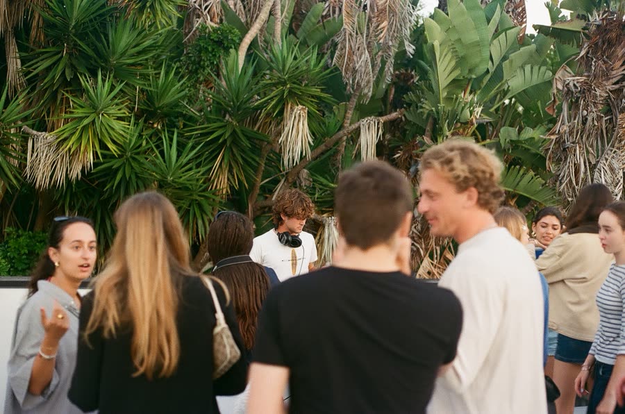 DJ setup under palms at a DISQ event
