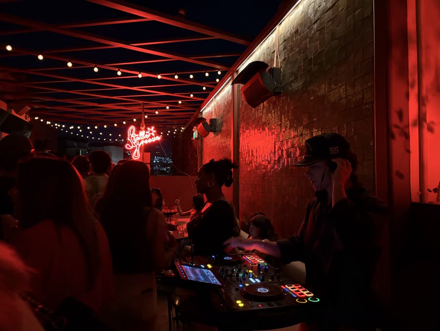 DJ set in a red-lit room at a DISQ event